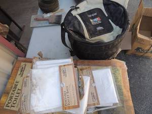 lot 322 image: collapsible cooler and numerous portable toilet liners