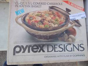 lot 363 image: Pyrex covered 1.5 QT casserole in rattan basket design