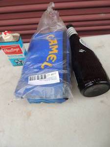 lot 677 image: Coors lite glass bottles bat, camel bag and glove oil