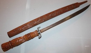 lot 55 image: Southeast Asian Thai Dhah sword with carved wooden handle and scabbard