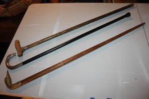 lot 107 image: antique walking canes featuring decorative handles