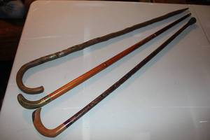 lot 112 image: vintage primitive folk art walking stick and walking stick featuring a brass snake-head handle and more see pictures for details