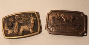 lot 179 image: vintage brass belt buckle featuring a Cocker Spaniel dog and the text come n get it & vintage 1976 Indiana Metal Craft Winchester belt buckle featuring a mountain lion