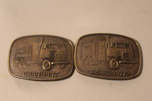 lot 180 image: 2-vintage Gearhart Trucks brass-toned promotional belt buckles from the 1980s