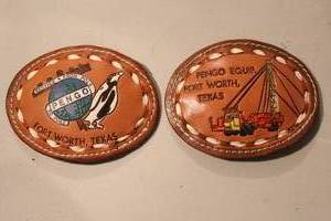 lot 182 image: vintage Pengo Equipment leather belt buckles featuring a crane scene and Fort Worth, Texas