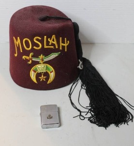 lot 218 image: vintage Moslah Temple Shriner Masonic Fez, typically made of maroon felt with gold-toned embroidery and a long black tassel and a Zippo Masonic symbol brushed chrome lighter