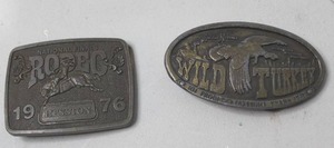 lot 303 image: vintage 1976 Hesston National Finals Rodeo belt buckle & vintage 1970s Austin Nichols Wild Turkey bourbon belt buckle