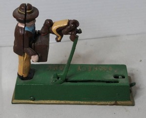 lot 380 image: cast iron mechanical monkey bank with bonus change inside
