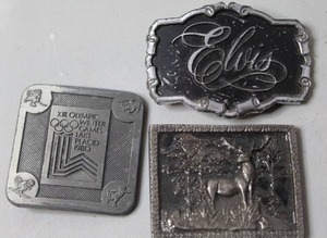 lot 390 image: vintage 1980 Lake Placid Winter Olympics belt buckle &  vintage Elvis Presley Guitar Man belt buckle & vintage silver-toned metal belt buckle featuring a detailed relief of an elk