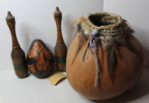 lot 438 image: traditional hand-carved gourd ornament & handcrafted gourd vessel adorned with a coiled fiber rim, feathers, and decorative beads & vintage wooden Indian clubs