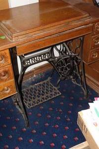 lot 444 image: vintage Singer treadle sewing machine set within a wooden cabinet