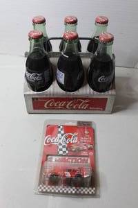 lot 451 image: vintage Coca-Cola six-pack bottle carrier featuring aluminum or metal construction with glass bottles & 1998 Action Racing 164 scale diecast car of Dale Earnhardt Sr.s #3 Coca-Cola Monte Carlo