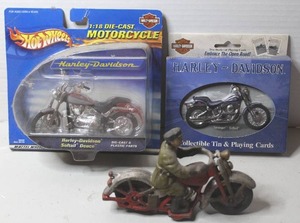 lot 458 image: cast iron toy resembles a vintage Hubley motorcycle patrol figure & 2000 Hot Wheels Harley-Davidson Softail Deuce 118 scale die-cast motorcycle & 2001 Harley-Davidson Springer Softail collectible tin containing two decks of playing cards