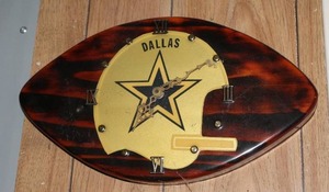 lot 460 image: Dallas Cowboys football-shaped wall clock featuring the team logo.