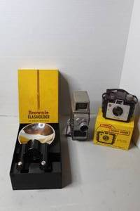 lot 473 image: vintage Kodak Brownie Flashholder packaging box for the Six-20 camera & vintage Bell & Howell Electric Eye 8mm movie camera.& vintage 1950s Eastman Kodak Brownie Holiday camera with its original yellow box
