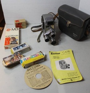 lot 474 image: vintage Keystone Capri Model K-27 8mm rollfilm movie camera with the original instruction booklet vintage Sylvania Blue Dot flashcubes
