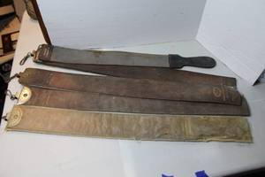 lot 483 image: These are antique leather razor strops. These items were used by barbers for sharpening straight razors
