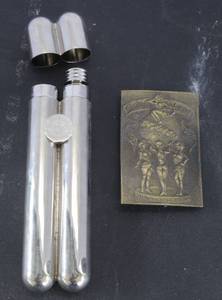 lot 502 image: polished metal dual-chamber cigar holder and flask combo & vintage 1970s Feel on Top of the World Coca-Cola brass belt buckle