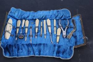 lot 524 image: vintage celluloid manicure set in a velvet-lined roll-up case