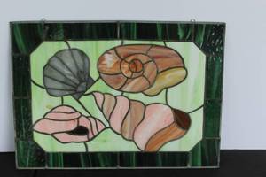 lot 547 image: vintage stained glass window panel featuring seashell designs with a dark green border about 20 in by 15 in