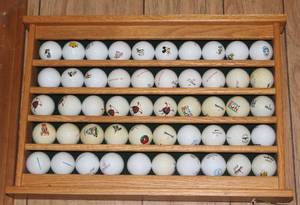 lot 555 image: solid hardwood golf ball display rack in a natural oak finish with all the golf balls