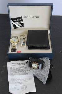 lot 564 image: vintage Cte dAzur boxed gift set featuring a quartz wristwatch with a silver and gold-tone band, a matching keychain, and a black wallet and  Awny Sport womens wristwatch featuring a rectangular gold-tone case and a wide black leather cuff band