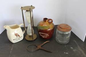 lot 575 image: vintage brass nautical-style hourglass sand timer & vintage Wild Turkey Bourbon ceramic water pitcher & vintage ceramic Arkansas Mountain Dew moonshine jug & much more see pictures for details