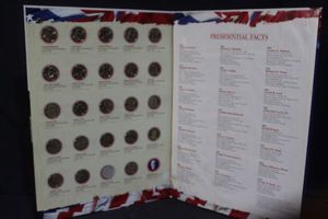 lot 7 image: Twenty-three presidential dollar coins in collectable display&nbsp