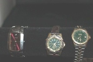 lot 21 image: Three Vintage Guess Watches, Japan Quartz Movement, Red Rectangular Silver Tone Link Band, Two emerald Green Watches, one with brown leather band, one with two-tone link band all need batteries