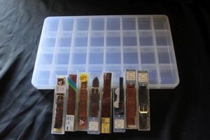 lot 229 image: Divided plastic box and replacement watch bands