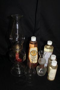 lot 236 image: Vintage Oil lamp and extra bottles of lamp oil