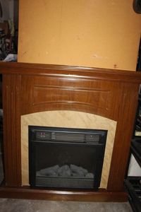lot 269 image: Electric RV Style Fireplace insert and mantle approx 4ft tall&nbsp