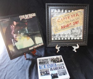 lot 371 image: Framed Stevie Ray Vaughan album cover, Movie ticket art, The Beatles book