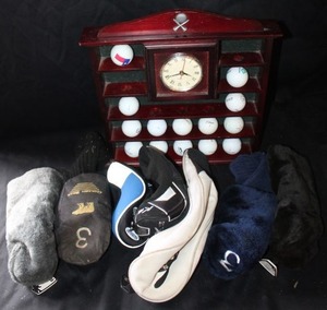 lot 394 image: Golf items, golf ball clock display, club head covers