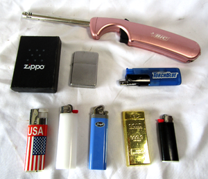 lot 129 image: Zippo lighter and other lighters as shown