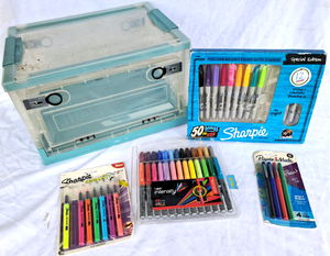 lot 149 image: Sharpie markers, Paper Mate felt tip markers, Bic permanent markers, and a collapsible storage box