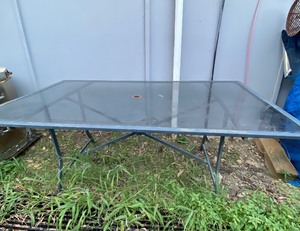 lot 260 image: Glass Outdoor Patio Table, Approx. Item Dimensions (66 L x 38 W x 28 34 H) - In Condition As Shown