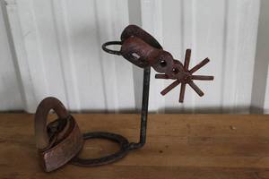 lot 52 image: vintage Mrs. Potts sad iron and western-style rowel spur Dcor