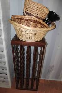 lot 126 image: dark wood, freestanding wine rack and baskets and table lamp