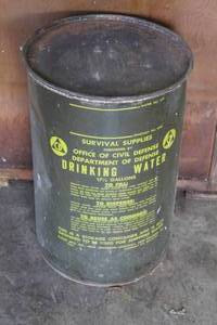 lot 60 image: vintage 17.5-gallon Cold War-era Civil Defense drinking water storage container from the 1960s.