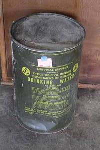 lot 61 image: vintage 17.5-gallon Cold War-era Civil Defense drinking water storage container from the 1960s.