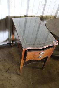 lot 223 image: vintage end table with a bow-front silhouette, decorative glass top, and tapered feet