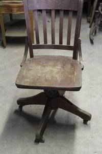lot 250 image: vintage banker chair featuring a swivel mechanism and cast iron hardware on wood construction