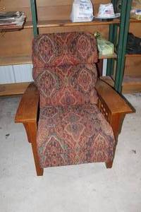 Mission-style reclining lounge chair features a patterned fabric upholstery and sturdy oak wood arms