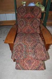 Mission-style reclining lounge chair features a patterned fabric upholstery and sturdy oak wood arms