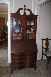 lot 374 image: mahogany Governor Winthrop-style secretary desk featuring a serpentine front, ball and claw feet, and a glass-doored bookcase top(contents not included)