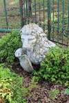 stone garden statue of a lion holding a shield
