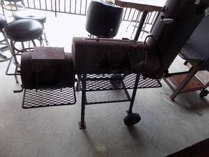 lot 101 image: NEW BRAUNFELS off set smoker. Heavy duty construction fire box horizontal cooking chamber with vertical smoke stack and grates