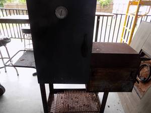 lot 63 image: OKLAHOMA JOES  Smoker with 4 shelves hinge on fire box needs to be reattached  really good shape