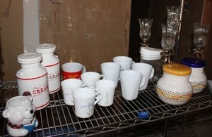 lot 92 image: Candle holder centerpiece, mug sets, and kitchen cannisters